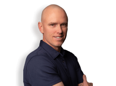 headshot of man smiling with arms crossed